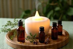 Aromatherapy oils and diffuser on wooden tray