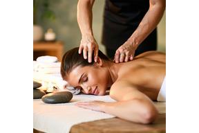 Massage therapist working on client’s back in a peaceful room